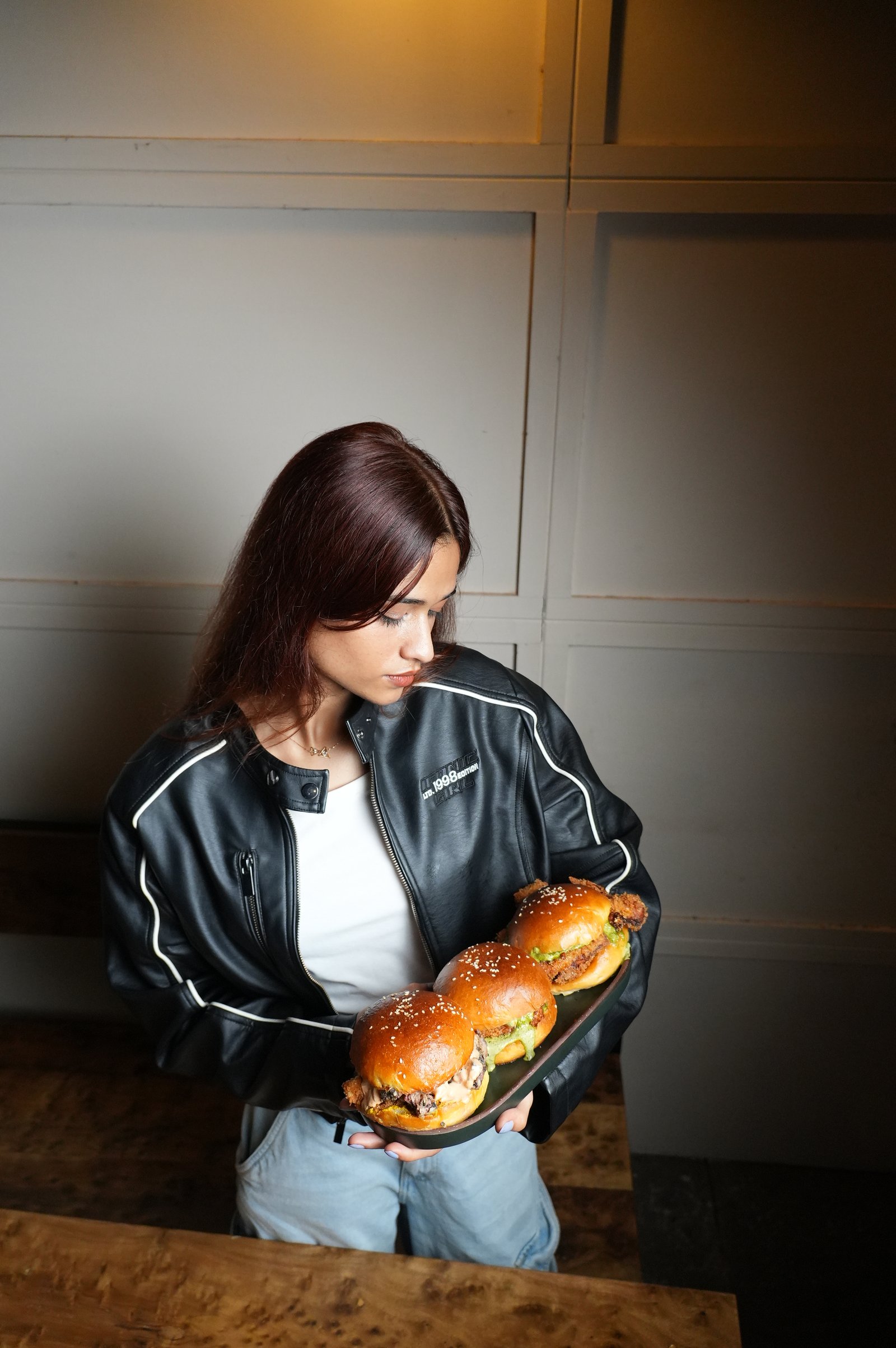 Guest holding a platter of PuKa sliders