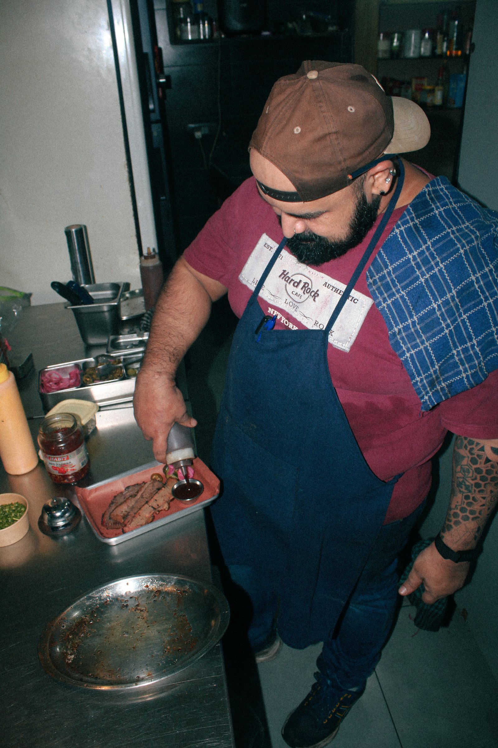 Pitmaster plating smoked brisket in the kitchen
