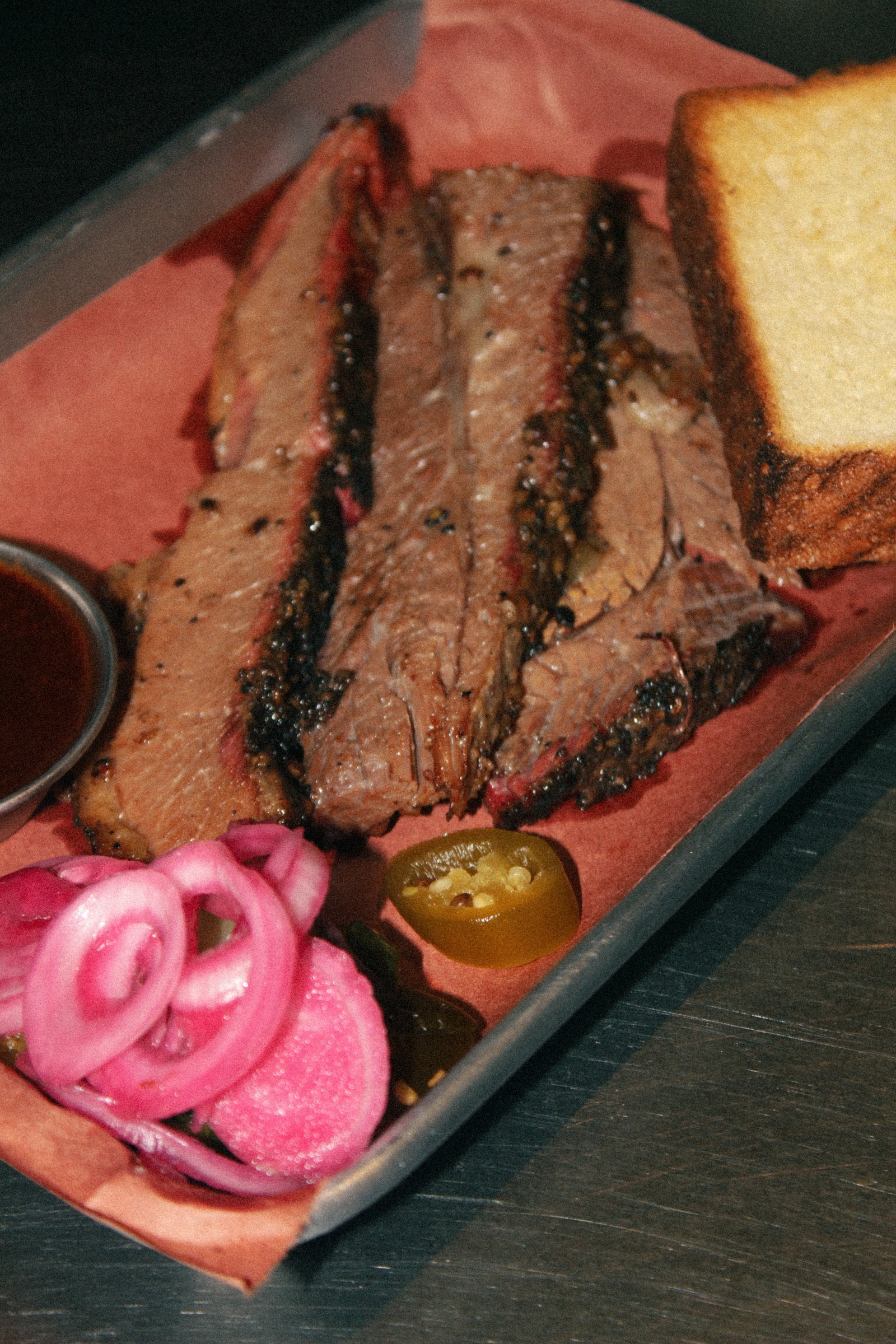 Smoked brisket sliced and served with sauce