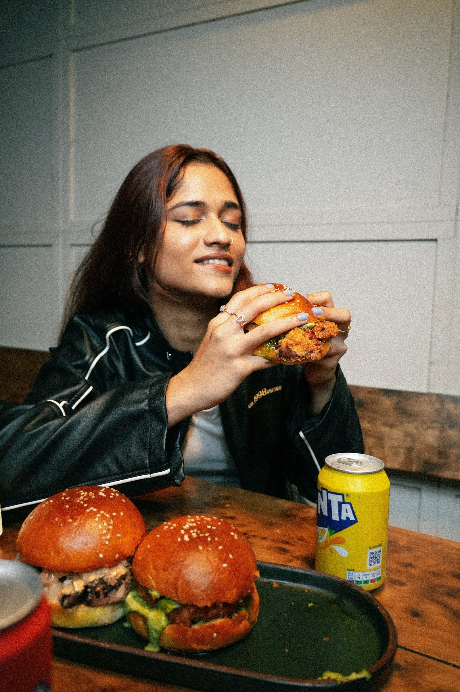 Guest biting into a PuKa smoked burger